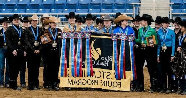 Group of Western riders standing with ribbons & awards